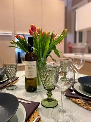 a table with a bottle of wine and a vase of flowers at Ultimate Downtown Athens Escape in Athens