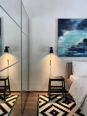 a bedroom with a bed and two chairs and a table at Ultimate Downtown Athens Escape in Athens