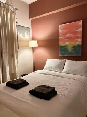 a bedroom with a bed with two towels on it at Ultimate Downtown Athens Escape in Athens
