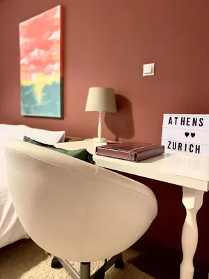 a white desk with a chair and a book on it at Ultimate Downtown Athens Escape in Athens