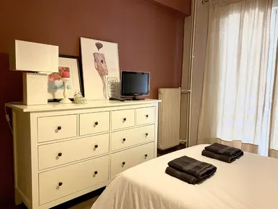 a bedroom with a bed and a dresser with two towels at Ultimate Downtown Athens Escape in Athens