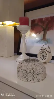 a table with a candle and a clock on it at Ultimate Downtown Athens Escape in Athens