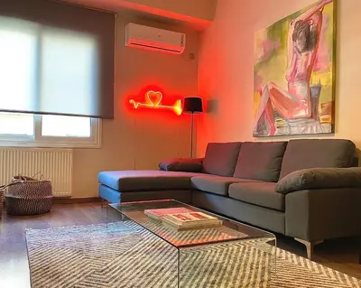 a living room with a couch and a table at Ultimate Downtown Athens Escape in Athens
