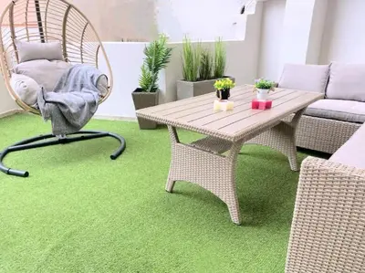 a living room with a table and a chair and green carpet at NEW AmazingLarge Luxury 4BR Suite/1min toAcropolis in Athens