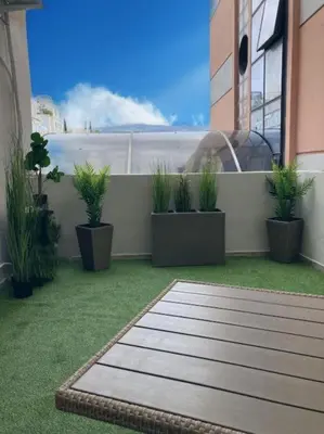 a balcony with potted plants on a building at NEW AmazingLarge Luxury 4BR Suite/1min toAcropolis in Athens