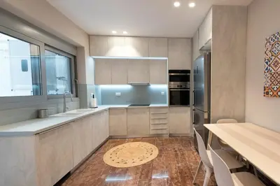 a kitchen with a sink and a refrigerator at Athenais Luxury Apartment in Athens