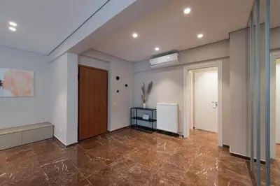 an empty room with a door and tile floor at Athenais Luxury Apartment in Athens
