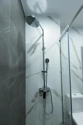 a shower stall in a bathroom with a toilet at Athenais Luxury Apartment in Athens
