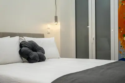 a black pillow sitting on top of a bed at 