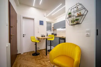 a kitchen with a yellow chair and a table at 