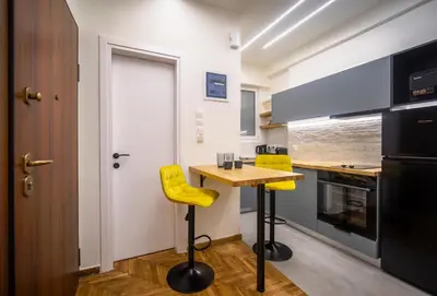 a kitchen with a wooden table and yellow chairs at 