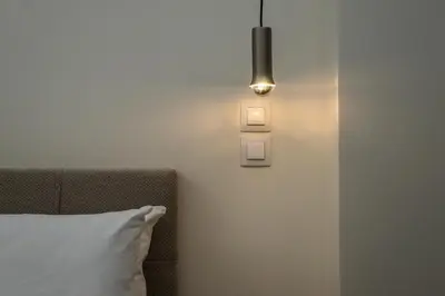 a room with a bed and a light on the wall at 
