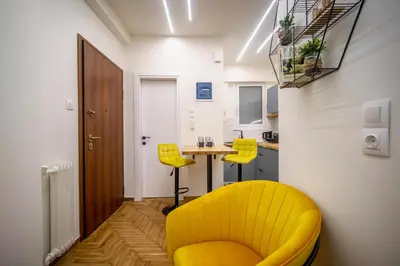 a yellow chair and a table in a room at 