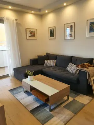 a living room with a couch and a coffee table at Tony's suite with parking in Athens
