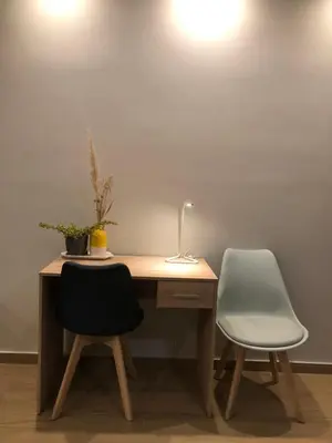 a desk with two chairs and a lamp on it at Tony's suite with parking in Athens