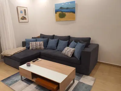 a living room with a couch and a coffee table at Tony's suite with parking in Athens
