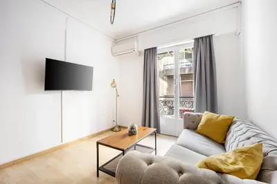 a living room with a couch and a table at Lovely apartment in the heart of Athens in Athens