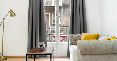 a living room with a couch and a table at Lovely apartment in the heart of Athens in Athens
