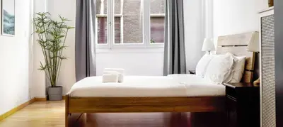 a bedroom with a large bed and a window at Lovely apartment in the heart of Athens in Athens