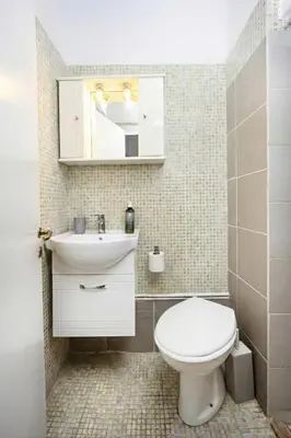 a bathroom with a white toilet and a sink at Lovely apartment in the heart of Athens in Athens