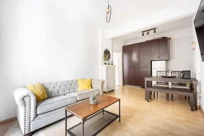 a living room with a couch and a table at Lovely apartment in the heart of Athens in Athens
