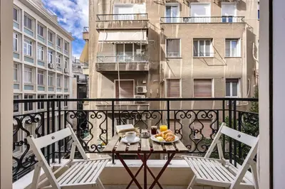 a balcony with a table and chairs on a balcony at Lovely apartment in the heart of Athens in Athens