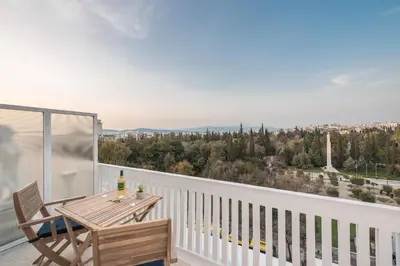 a balcony with a table and chairs and a view at The 