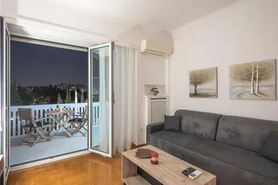 a living room with a couch and a large window at The 