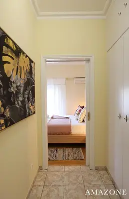 a bedroom with a bed and a window at MELMA PROPERTIES-AMAZONE-premium apartment in Piraeus center in Piraeus