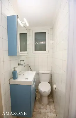 a white bathroom with a toilet and a sink at MELMA PROPERTIES-AMAZONE-premium apartment in Piraeus center in Piraeus