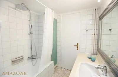 a white bathroom with a tub and a sink at MELMA PROPERTIES-AMAZONE-premium apartment in Piraeus center in Piraeus