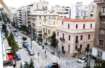 a view of a city street with cars and buildings at MELMA PROPERTIES-AMAZONE-premium apartment in Piraeus center in Piraeus