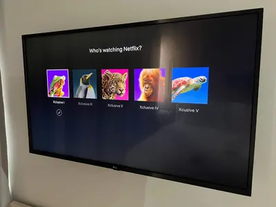 a flat screen tv hanging on a wall at Xclusive Athens Suites in Athens