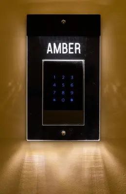 a black alarm clock with the word amler on it at Xclusive Athens Suites in Athens