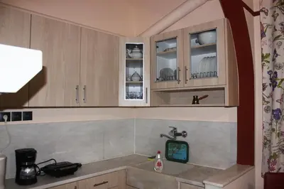 a kitchen with wooden cabinets and a sink at Capital apartment next to Metro station with parking spot to explore Athens in Athens