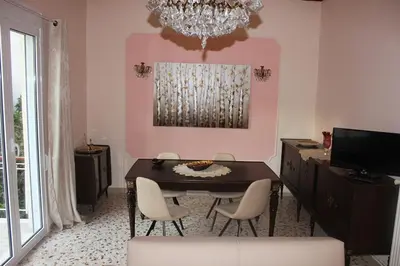 a dining room with a table and chairs and a chandelier at Capital apartment next to Metro station with parking spot to explore Athens in Athens