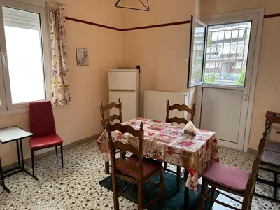 a kitchen with a table and chairs and a refrigerator at Capital apartment next to Metro station with parking spot to explore Athens in Athens