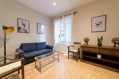 a living room with a blue couch and a table at Heart of Athens Thisio in Athens