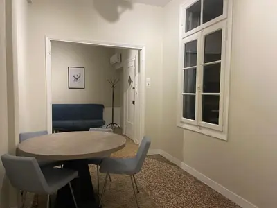 a room with a table and chairs and a window at Heart of Athens Thisio in Athens