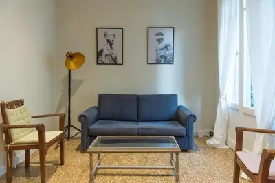a living room with a blue couch and a table at Heart of Athens Thisio in Athens