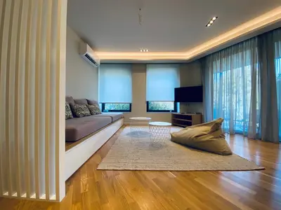 a living room with a couch and a television at Acropolis Residence #Rooftop#360-Degree City Views #Unoblu in Athens