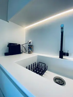 a kitchen with a white counter with a sink at Acropolis Residence #Rooftop#360-Degree City Views #Unoblu in Athens