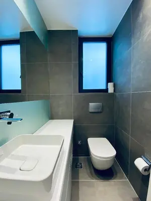 a bathroom with a toilet and a sink and a tub at Acropolis Residence #Rooftop#360-Degree City Views #Unoblu in Athens
