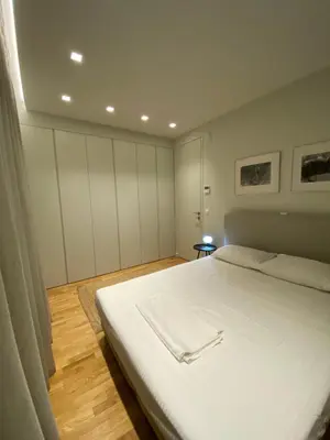 a bedroom with a large white bed in it at Acropolis Residence #Rooftop#360-Degree City Views #Unoblu in Athens