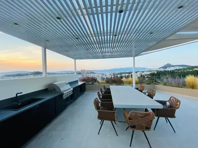 a kitchen and dining room with a table and chairs at Acropolis Residence #Rooftop#360-Degree City Views #Unoblu in Athens