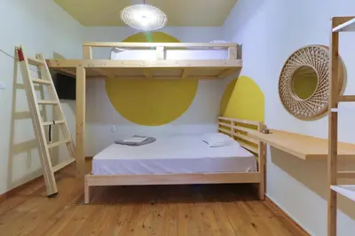 a bedroom with bunk beds and a ladder at athensvintage in Athens