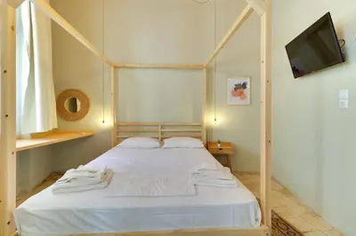a bedroom with a bed with a wooden frame at athensvintage in Athens