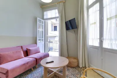 a living room with a purple couch and a table at athensvintage in Athens