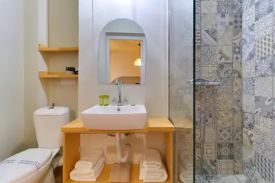 a bathroom with a sink and a toilet and a shower at athensvintage in Athens