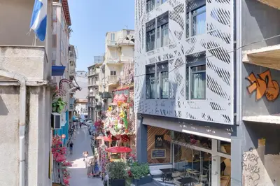 an empty street in a city with buildings at athensvintage in Athens